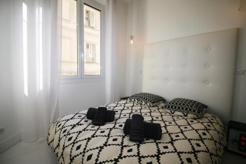 - une chambre avec un lit doté de draps noirs et blancs et une fenêtre dans l'établissement High-End Apartment, Hyper Center, Near The Beaches, à Nice