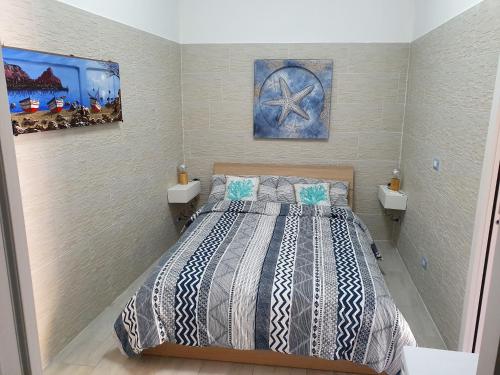 a bedroom with a bed and two sinks in it at Posidonia in Porticello