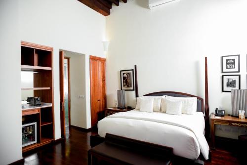 a bedroom with a large white bed with white pillows at Hotel Casa Blanca 7 in San Miguel de Allende