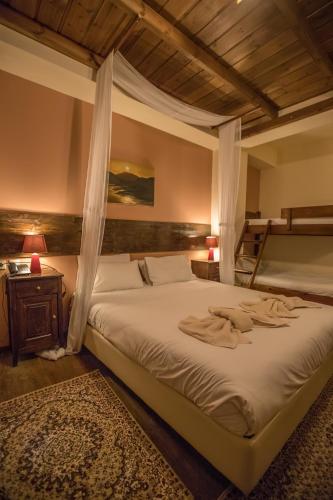 a bedroom with a large bed with a canopy at Archontiko Zakoni in Neochori