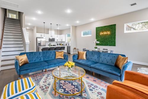 a living room with blue couches and a table at 3 Bedroom and 3 bath in Houston