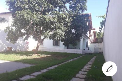 a house with a tree in the yard at Casa de praia P Grande in Fundão