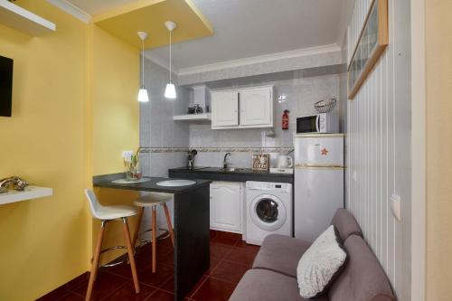 a kitchen with a couch and a table in a room at Alojamento Bela Vista in Lajes do Pico