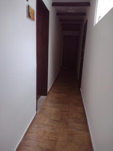 an empty hallway with a wood floor and a door at Los Ríos in Pereira
