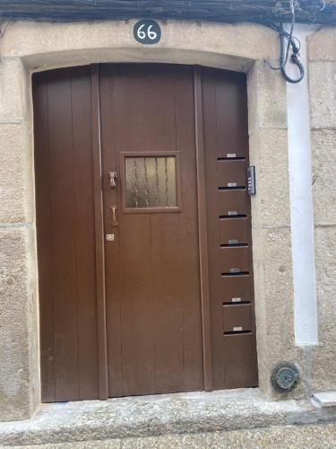 a brown door with the number six on it at C & H Studio in Guimarães