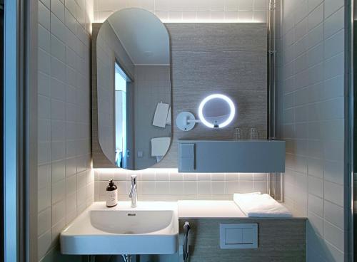 a bathroom with a sink and a mirror at SpaHotel Hamina in Hamina