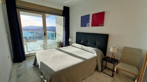 1 dormitorio con cama y ventana grande en Stunning sea views from a 2-bedroom apartment on the 26th floor, en Benidorm