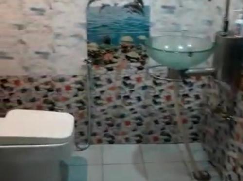 a bathroom with a sink and a toilet at Bluepine Cottages Pangot by Nature Nests in Nainital