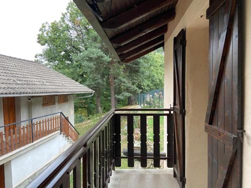 an open door to a balcony of a house at Secou d'Fredu - la casa nel bosco in San Damiano Macra