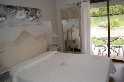 a bedroom with a bed and a table and a window at Hôtel Le Colombier in Moustiers-Sainte-Marie