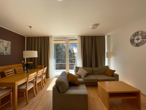 a living room with a couch and a table at JZ Apartments - Pohorje in Maribor