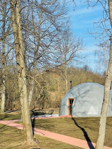 a dome tent in a park with trees at VasaRojaus Kupolai in Birštonas
