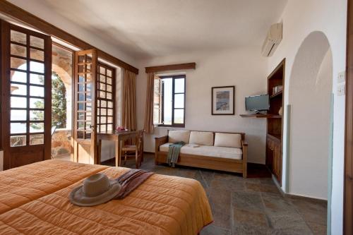 a bedroom with a bed with a hat on it at Kalamitsi Hotel in Kardamyli
