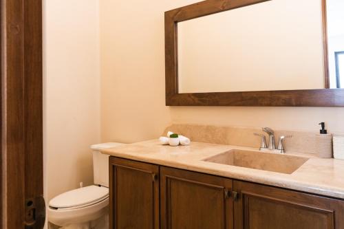 a bathroom with a sink and a toilet at Desert Villas Cabo in Cabo San Lucas