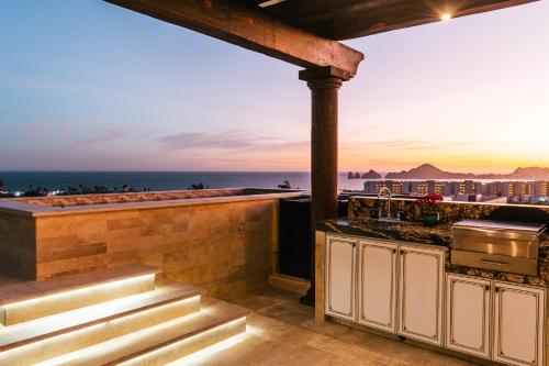 a rooftop kitchen with a view of the ocean at Desert Villas Cabo in Cabo San Lucas