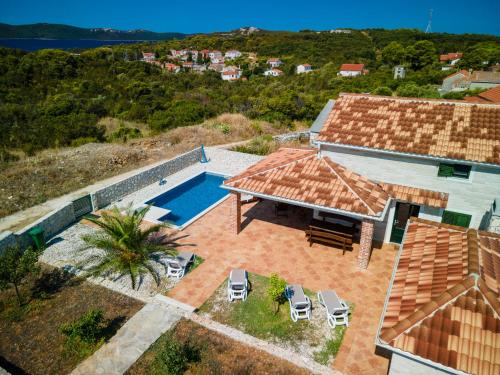 an aerial view of a house with a swimming pool at Villa Molat in Molat