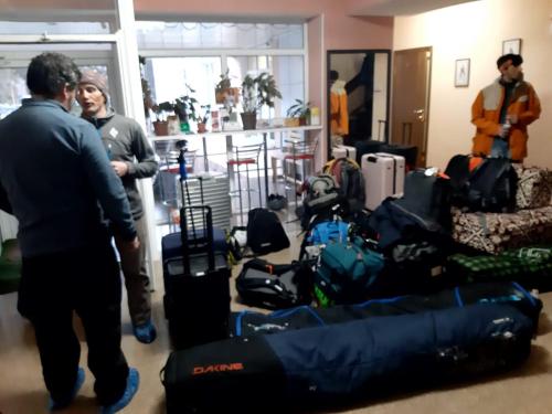 two people standing in a room with a pile of luggage at Tagaytay Karakol Hotel in Karakol