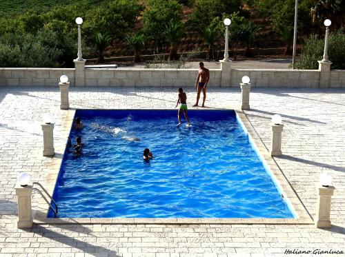 a group of people playing in a swimming pool at Hotel Bed&Breakfast Tiffany in Campobello di Licata
