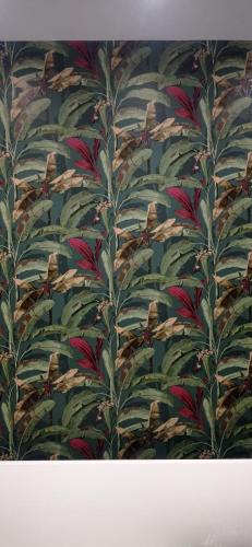 a wallpaper with a bunch of leaves on a wall at Bed Nonnonino in Porto Cesareo