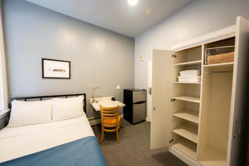 a small room with a bed and a desk at The Urban in San Francisco