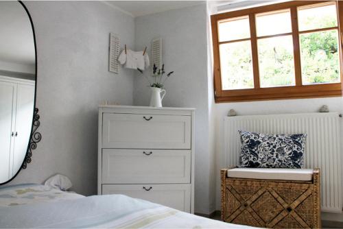 a bedroom with a bed and a dresser and a mirror at Loblocher Max und Moritz in Neustadt an der Weinstraße