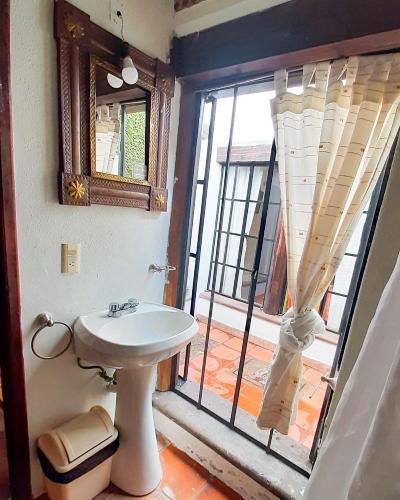 a bathroom with a sink and a large window at Hotel Real Guanajuato in Guanajuato