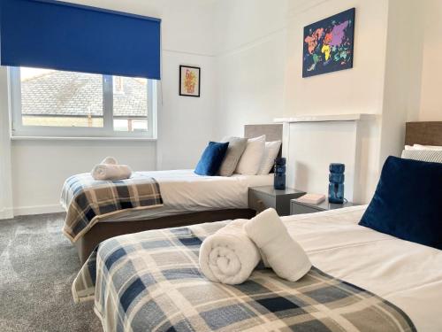 A bed or beds in a room at Bella House - 3 bed house in Glasgow