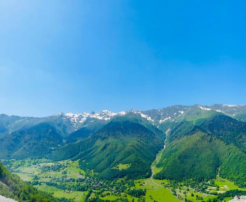 a view of a valley in the mountains at Apartment Jorjo Mestia in Mestia