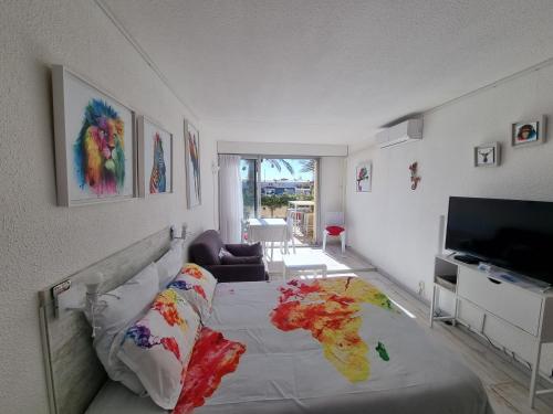 a bedroom with a bed and a television in it at Cap Capistol Studio avec terrasse, vue port in Cap d'Agde