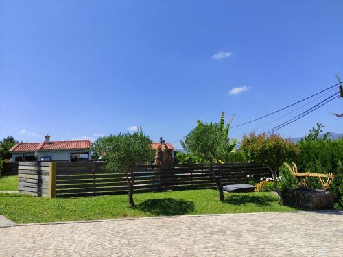a wooden fence with a bench in front of a house at Casas do Paço - Casas de Férias in Cabeceiras de Basto