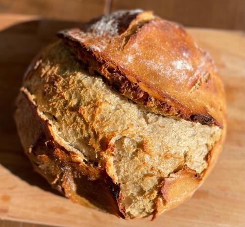 a loaf of bread sitting on top of a cutting board at Stepping Stones Glamping little red in Bantry