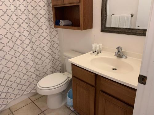 a bathroom with a toilet and a sink at Cheerful 3-bedroom with a pool in San Antonio