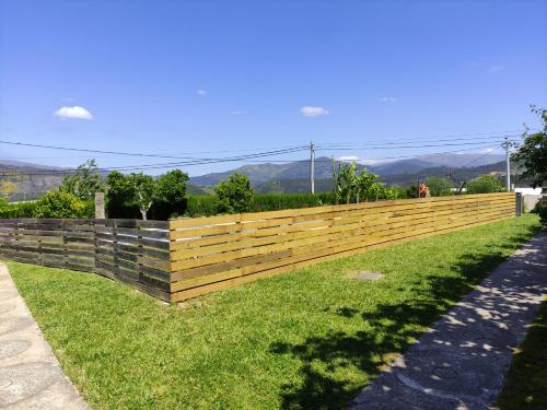 a wooden fence on the side of a grass field at Casas do Paço - Casas de Férias in Cabeceiras de Basto