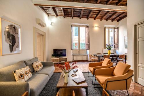 sala de estar con sofá, sillas y mesa en YourSuiteRome, en Roma
