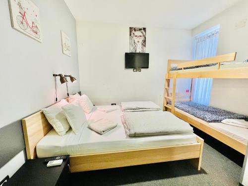 a bedroom with two bunk beds and a television at Himalayan Hostel in Zagreb