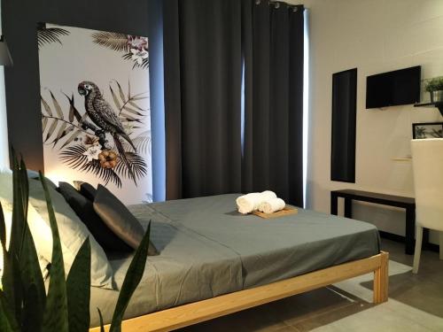 a bedroom with a bed with two towels on it at 87029house in Scalea