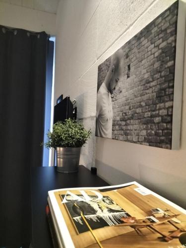 a table with a picture of a woman on a brick wall at 87029house in Scalea
