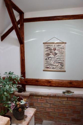 a room with a brick wall and a picture on the wall at Penzion U Kapra in Roudnice nad Labem