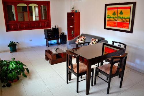 a living room with a table and chairs at Hotel Itzamana in Iza