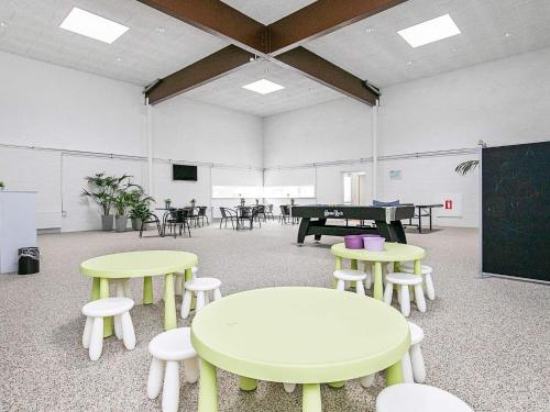 a classroom with tables and chairs and a chalkboard at 4 person holiday home in Brovst-By Traum in Brovst