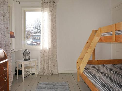 a bedroom with a bunk bed and a window at Holiday home GAMLEBY V in Gamleby