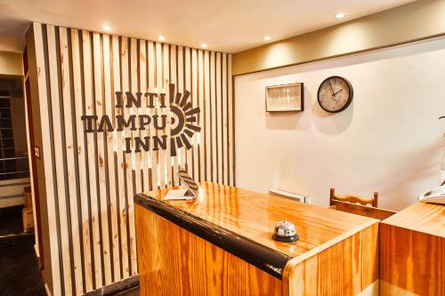 a law office with a desk and a clock on the wall at Inti Tampu Inn in Cusco