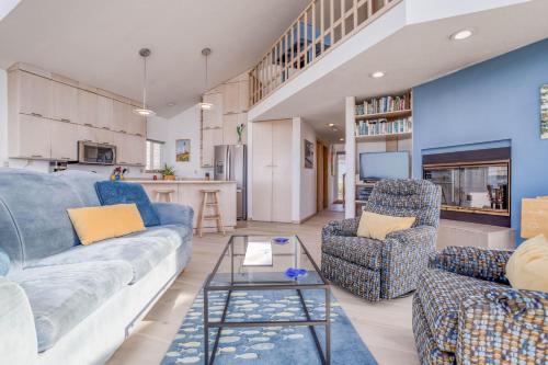 a living room with a couch and two chairs at Kellys Cove in Yachats