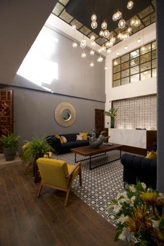 a living room with a couch and a table at Hotel Boutique Casa Loreta in Querétaro