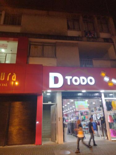 two people walking in front of addo store at night at Los Ríos in Pereira