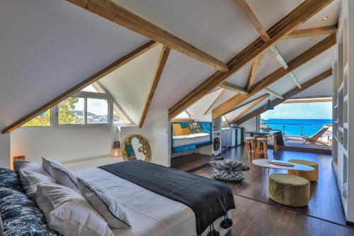 a bedroom with a large bed and a living room at MOJITO in Grand Case