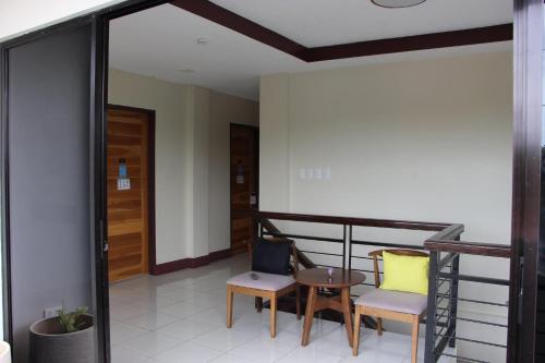 a balcony with two chairs and a table at V.P. GO INN in Solangon