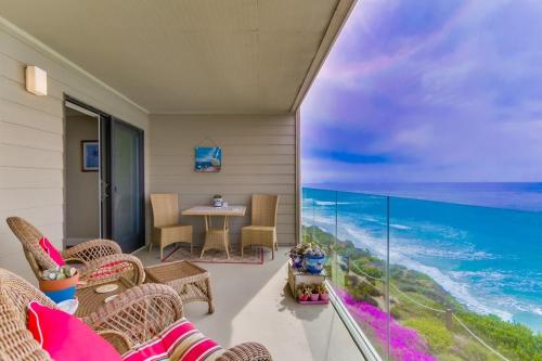 a balcony with a table and chairs and a view of the ocean at Work Friendly Oceanfront SURF25 Condo in Solana Beach