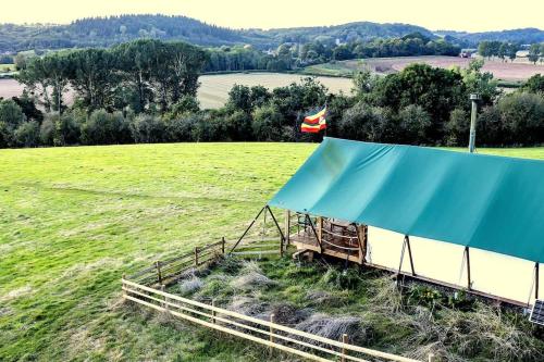 an image of a field with a tent at Hakuna Matata Safari Lodge - Sublime, off-grid digital detox with hot tub in Shelsley Walsh