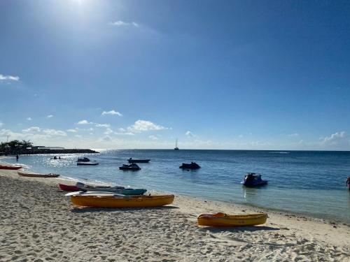 a beach with several boats in the water at Lagoona Sunset in Maafushi